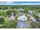 Aerial view of community amenities featuring a pool, parking area, and sports court surrounded by lush landscaping at 2533 Grassy Point Dr # 215, Lake Mary, FL 32746
