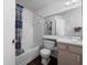 Bright bathroom featuring a bathtub and vanity with wood cabinets at 2533 Grassy Point Dr # 215, Lake Mary, FL 32746