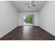 Bedroom featuring a ceiling fan, a patio door, and wood floor at 2533 Grassy Point Dr # 215, Lake Mary, FL 32746