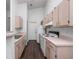 Bright kitchen featuring wood cabinets, appliances, and dark wood floor at 2533 Grassy Point Dr # 215, Lake Mary, FL 32746
