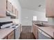 Bright kitchen featuring wood cabinets, appliances, and dark wood floor at 2533 Grassy Point Dr # 215, Lake Mary, FL 32746