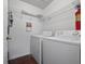 Practical laundry room featuring white appliances and wire shelving at 2533 Grassy Point Dr # 215, Lake Mary, FL 32746