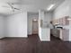 Open concept living room and kitchen with modern appliances and wood floors at 2533 Grassy Point Dr # 215, Lake Mary, FL 32746