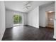 Bright living room with wood floors and a sliding glass door to a balcony at 2533 Grassy Point Dr # 215, Lake Mary, FL 32746