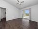 Spacious main bedroom with wood floors and a sliding glass door to a balcony at 2533 Grassy Point Dr # 215, Lake Mary, FL 32746