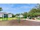 Community playground with swings, slides, and a basketball hoop, perfect for active fun and recreation at 2533 Grassy Point Dr # 215, Lake Mary, FL 32746