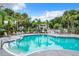 Community pool with seating, hot tub, and lush landscaping, offering a refreshing oasis for relaxation at 2533 Grassy Point Dr # 215, Lake Mary, FL 32746