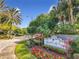 Community sign with lush landscaping at the entrance at 2533 Grassy Point Dr # 215, Lake Mary, FL 32746