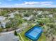 Aerial view of a blue tennis court, lush trees and manicured grounds at 2533 Grassy Point Dr # 215, Lake Mary, FL 32746