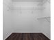 Spacious walk-in closet with wire shelving and wood floor at 2533 Grassy Point Dr # 215, Lake Mary, FL 32746