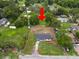 Aerial view of the home nestled on a grassy lot amid lush trees in a peaceful neighborhood at 2549 Gress Ln, Lakeland, FL 33805