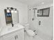 Modern bathroom featuring white marble tiling, glass shower, and contemporary vanity with black hardware at 2549 Gress Ln, Lakeland, FL 33805