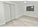 Bright bedroom with wood-look flooring, large closet, and a window bringing in natural light at 2549 Gress Ln, Lakeland, FL 33805