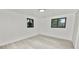 Spacious bedroom with new floors, white walls, and two windows, offering plenty of natural light at 2549 Gress Ln, Lakeland, FL 33805