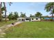 Beautifully landscaped front yard with a covered carport and well-maintained lawn enhancing curb appeal at 2549 Gress Ln, Lakeland, FL 33805