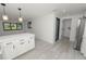 Modern kitchen with new stainless appliances and quartz island with adjacent pantry and laundry at 2549 Gress Ln, Lakeland, FL 33805