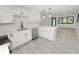 Sleek, open kitchen with stainless steel appliances, a breakfast bar, and bright, modern finishes at 2549 Gress Ln, Lakeland, FL 33805