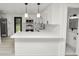 Bright, modern kitchen with quartz counters, stainless appliances, and stylish pendant lighting at 2549 Gress Ln, Lakeland, FL 33805