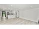 Bright, open-concept living space featuring sleek flooring and a modern, eat-in kitchen at 2549 Gress Ln, Lakeland, FL 33805