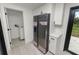 Modern Kitchen with new stainless fridge and pantry storage, plus adjacent laundry room at 2549 Gress Ln, Lakeland, FL 33805