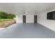 Covered patio with concrete floor, white walls and ceiling, offering a versatile outdoor space at 2549 Gress Ln, Lakeland, FL 33805