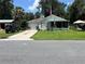 Charming single-story home with a well-maintained lawn and attached garage at 2597 Cr 426F, Lake Panasoffkee, FL 33538