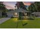 Charming single-story home with a well-manicured lawn, screened in porch, and American flags displayed at 2597 Cr 426F, Lake Panasoffkee, FL 33538