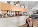 A view of the kitchen from the living room, showing it has room for a bar or breakfast counter at 2597 Cr 426F, Lake Panasoffkee, FL 33538