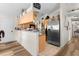 Bright kitchen featuring wood cabinets, stainless steel refrigerator, and wood-style floors at 2597 Cr 426F, Lake Panasoffkee, FL 33538
