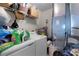 Functional laundry room featuring a washing machine, dryer, and storage shelves at 2597 Cr 426F, Lake Panasoffkee, FL 33538