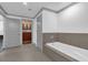 Bright bathroom with a soaking tub and access to a walk-in closet at 260 S Osceola Ave # 1406, Orlando, FL 32801