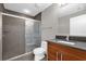 Modern bathroom featuring a glass door shower, gray tile and wood vanity at 260 S Osceola Ave # 1406, Orlando, FL 32801