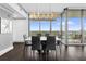 Modern dining room featuring dark wood floors, a stylish light fixture, and large windows with a city view at 260 S Osceola Ave # 1406, Orlando, FL 32801