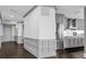 Elegant hallway featuring dark wood floors and decorative wall paneling leading to other rooms at 260 S Osceola Ave # 1406, Orlando, FL 32801