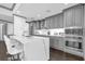 Modern kitchen showcasing a large island with bar seating, stainless steel appliances, and gray cabinetry at 260 S Osceola Ave # 1406, Orlando, FL 32801