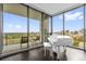 Living room with a white piano and large windows with cityscape views at 260 S Osceola Ave # 1406, Orlando, FL 32801