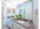 Modern bathroom with double sinks, light gray countertops, and a large mirror at 2924 Protagonist St, Kissimmee, FL 34746