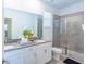 This bright bathroom features double sinks, neutral walls, and a large glass door shower at 2924 Protagonist St, Kissimmee, FL 34746