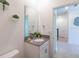 Powder room featuring a vanity with sink, toilet, modern decor, and white cabinetry at 2924 Protagonist St, Kissimmee, FL 34746