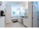 Bathroom with a soaking tub, double vanity, and stylish white cabinetry at 2924 Protagonist St, Kissimmee, FL 34746