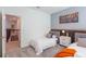 Modern bedroom with two beds, stylish bedside table and colorful wall art at 2924 Protagonist St, Kissimmee, FL 34746