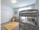This bedroom features bunk beds, neutral walls, and a playful natural lighting at 2924 Protagonist St, Kissimmee, FL 34746