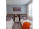 Modern bedroom with two beds, stylish bedside table and colorful wall art at 2924 Protagonist St, Kissimmee, FL 34746