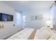 Modern bedroom with a mounted TV, dresser, and a view into the hallway at 2924 Protagonist St, Kissimmee, FL 34746