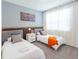 Modern bedroom with two beds, stylish bedside table and colorful wall art at 2924 Protagonist St, Kissimmee, FL 34746