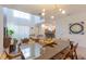 Elegant dining room with modern light fixture flows into the living area and kitchen for seamless entertaining at 2924 Protagonist St, Kissimmee, FL 34746