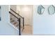 Hallway with stairs, modern railing, and geometric mirrors on the wall at 2924 Protagonist St, Kissimmee, FL 34746