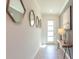 Hallway with tiled floors, modern decor, and natural light from the front door at 2924 Protagonist St, Kissimmee, FL 34746