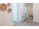 Hallway with a decorative wall art, leading to a bedroom and a bathroom at 2924 Protagonist St, Kissimmee, FL 34746