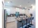 Modern kitchen boasts stainless steel appliances, a stylish island with bar seating and sleek cabinetry at 2924 Protagonist St, Kissimmee, FL 34746